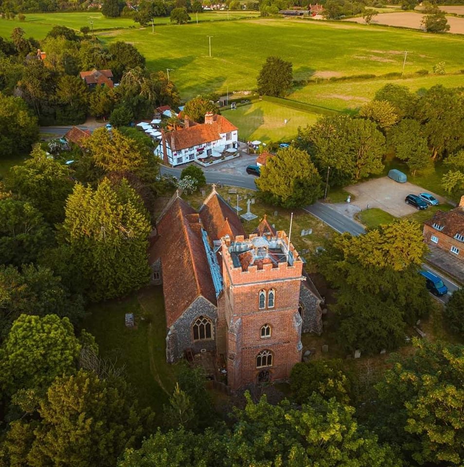 Aerial view of St Nicholas Church and surrounding churchyard in Hurst, Berkshire.